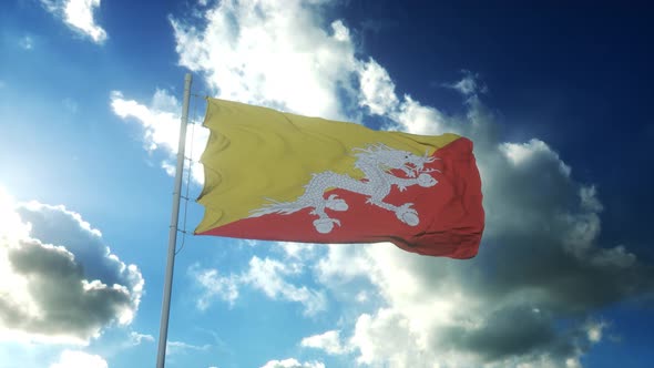 Flag of Bhutan Waving at Wind Against Beautiful Blue Sky alt