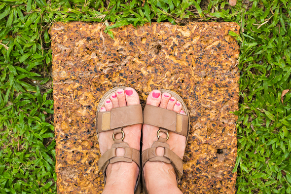 Feet selfie from upper view of a woman traveler in sandal