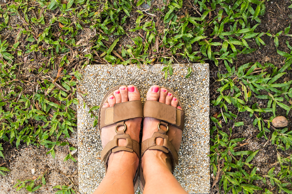 Feet selfie from upper view of a woman traveler in sandal - Stock Photo - Images