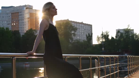 charming woman in the park at sunset