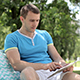 Young Man Typing On the Tablet In Nature - VideoHive Item for Sale