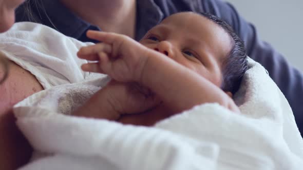 Close-up of Caucasian couple holding their newborn baby in the ward at hospital alt