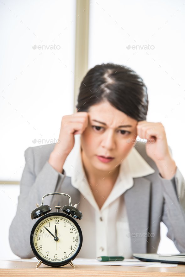 Young asian businesswoman worried about time