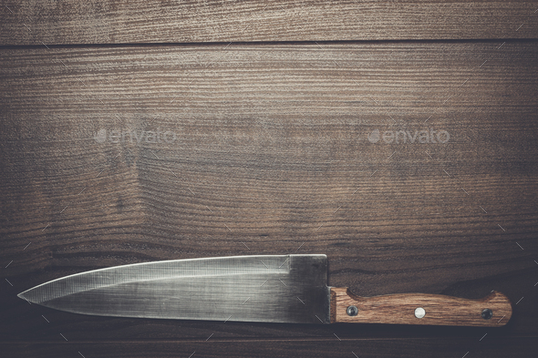 kitchen knife on brown wooden table