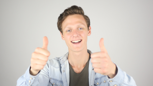 Young Boy Showing Thumbs up in Excitement of Achievement alt