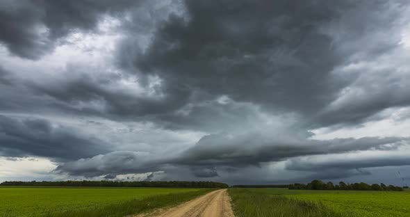 Atmospheric Storm Clouds Fast Moving Over the Ground. Climate Change and Global Warming alt