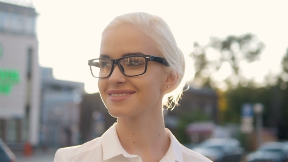 Portrait Of Young Beautiful Blonde Woman In The City Smiling In Sunset Backlight alt