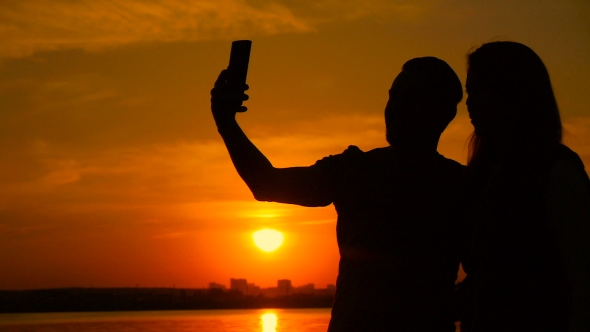 Young Couple Taking Selfie Photo On Beach During Sunset, Super 