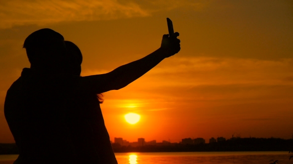 Young Couple Taking Selfie Photo On Beach During Sunset, Super 