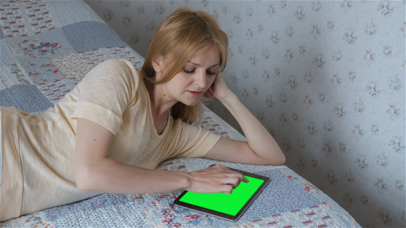 Beautiful Girl Using Tablet PC with Pre-Keyed Green Screen alt