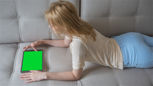 Beautiful Girl Using Tablet PC with Pre-Keyed Green Screen alt