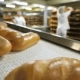 Bread On The Conveyor In The Background Of The Workers In The Bakery - VideoHive Item for Sale