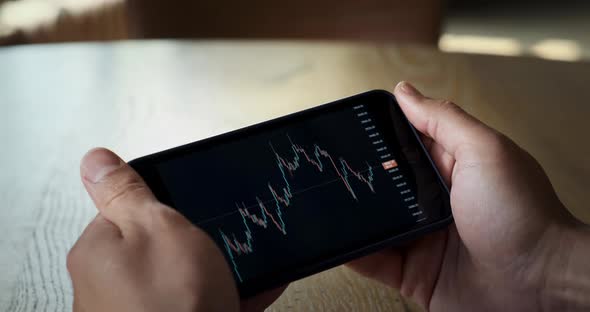 Businessman Using Smartphone with Stock Market Crypto Currency Bitcoin Trend Graph alt