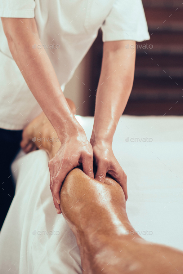 Sport massage, massaging legs - Stock Photo - Images