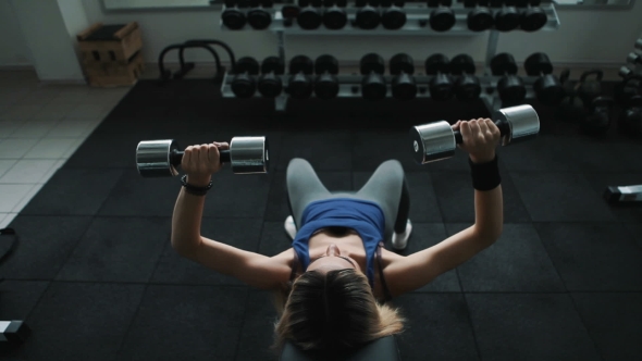 Athletic Girl In Gym Do Dumbbell Press On An Incline Bench alt