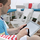 Young Man Typing on the Tablet in Nature - VideoHive Item for Sale