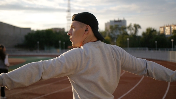 Young Athletic Man Doing Warm-Up Before Exercise And Jogging