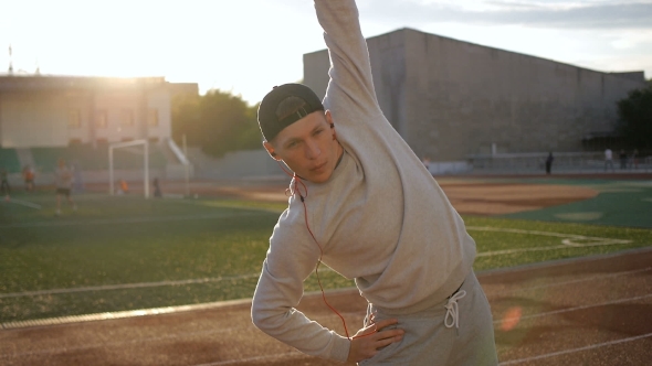 Young Athletic Man Doing Warm-up Before Exercise And Jogging