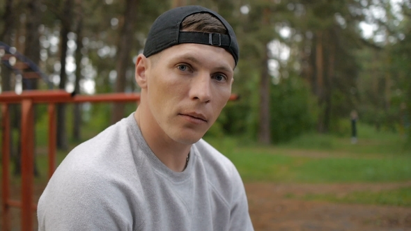 Portrait Of Handsome Young Man With Cap In Forest