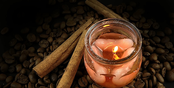 Coffee Beans with Cinnamon Sticks and Aromatic Candle on Black