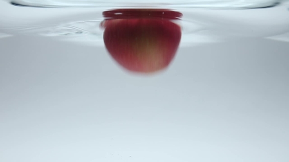 Two Apples Fruits Dropped Into Water