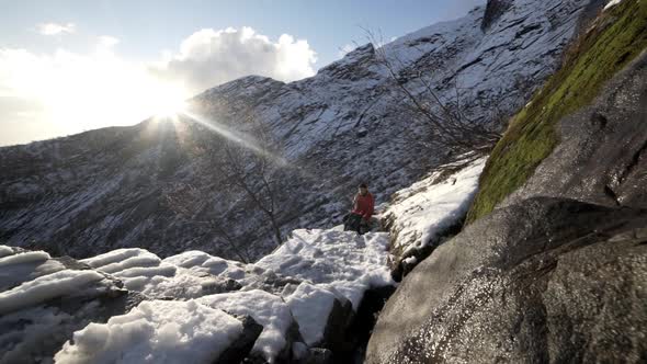 Mature Hiker Resting On Mountain Hike Under Bright Sun alt
