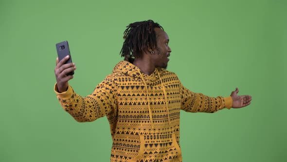 Young Handsome African Man Video Calling and Showing Phone alt