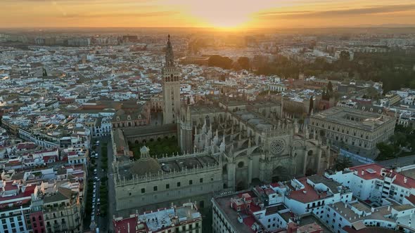 Aerial Sunset View of Gothic Cathedral in Seville Old Town with Famous Giralda Bell Tower alt
