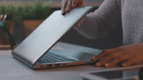 Woman opening her laptop and starting her work