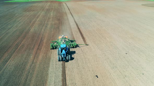 View of a Tractor, Sowing a Big Field. alt