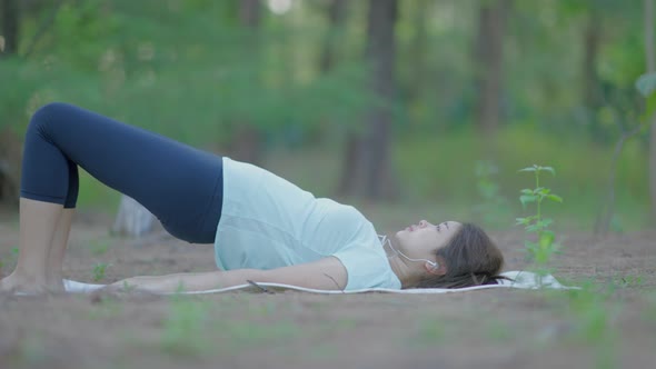 Asian cute girl She is doing yoga in the morning in the garden by the beach.