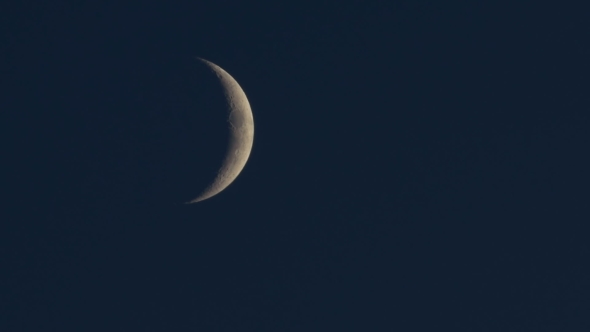  Of An Half Moon As It Rises In The Black Night Sky.