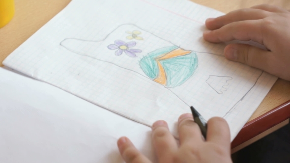 Little Girl Draws a Pictures In The Copybook