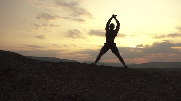 African American Bodybuilder Stretching At Sunset