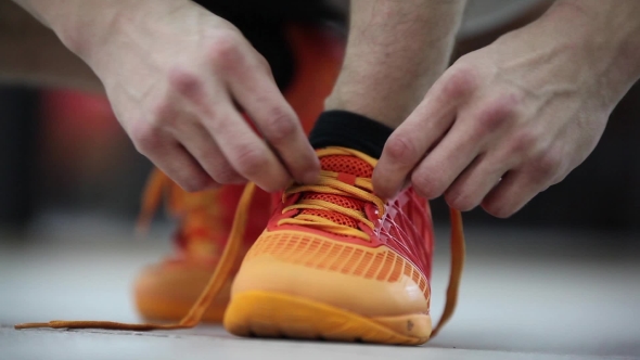 Athlete Tying Shoelaces On Sneakers