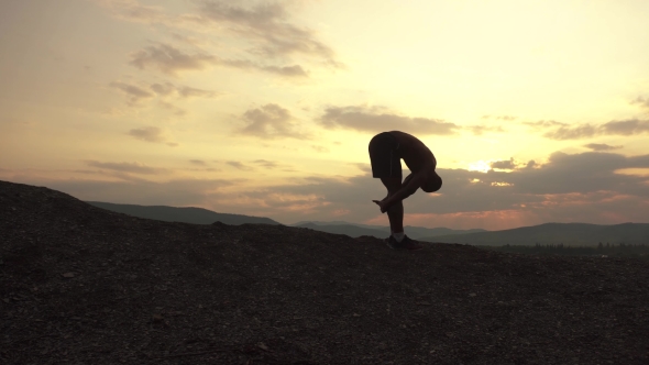 Silhouette Of African American Athlete Jogging On Sunset In Mountains. Cloudy Sky Background