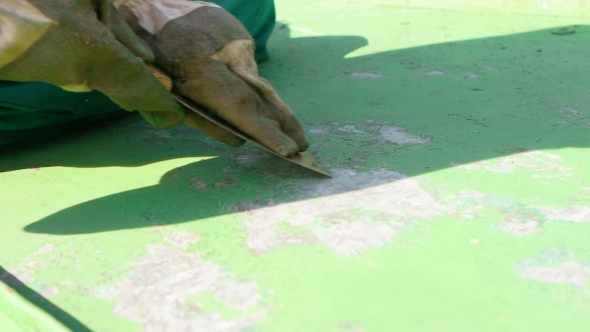 Scraping Off Green Layer Of Protective Paint