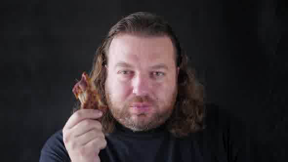 Man Biting With Relish A Piece Of Spare Ribs