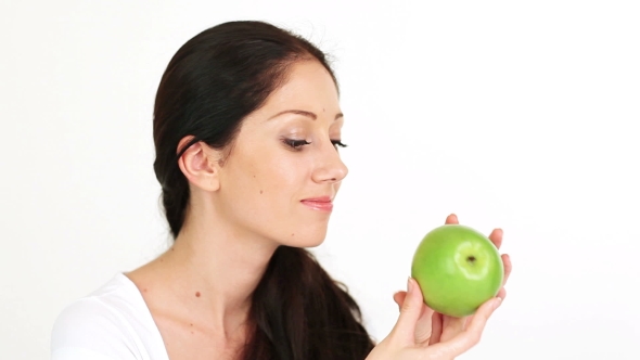 Young Attractive Woman Playing With Green Apple
