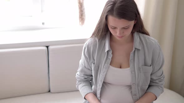 Authentic Cute Pregnant Woman with Pop It Feeling Happy at Home with Belly alt