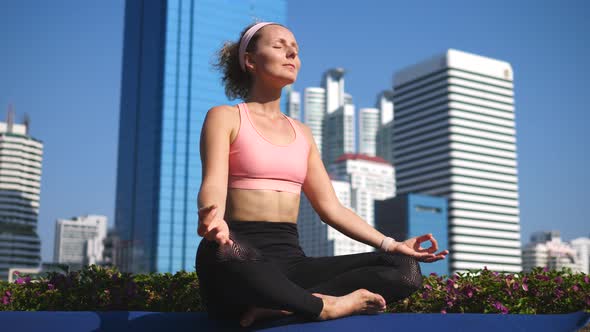 Young Fitness Woman Meditating And Exercise Yoga In City Park alt