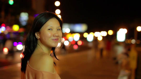 Happy Chinese Young Woman in City Center at Night