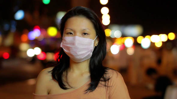 Chinese Girl Cover Her Face with Mask at Night