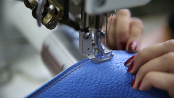 Worker Hands On Sewing Machine