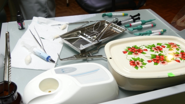 Dentist Hand And Dental Instruments  alt