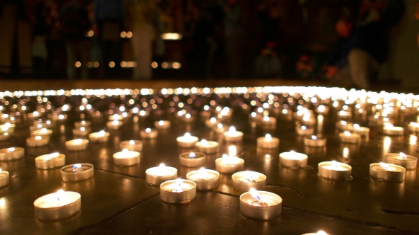 People In The Background Watching Burning Candles