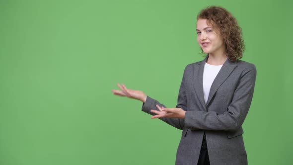 Young Happy Beautiful Businesswoman Showing Something alt