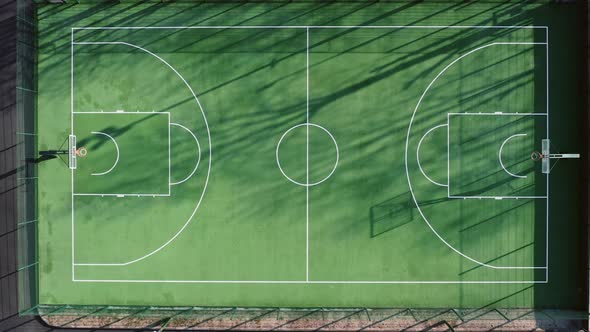 Empty Green Basketball Court in the Morning with Beautiful Soft Shadows  Top Aerial View alt