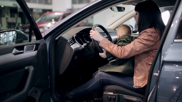 Mother And Son Inspecting Interior of New Car alt