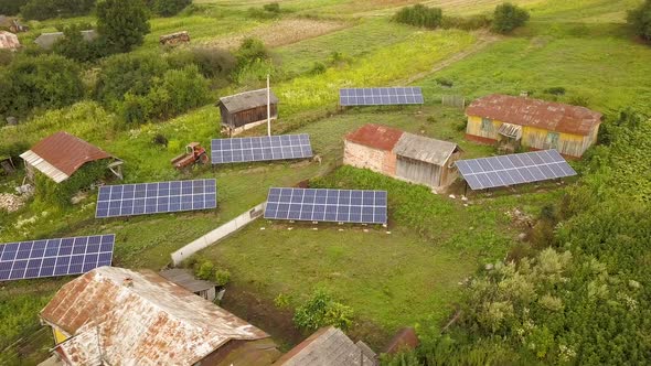 Aerial view of a row of  blue solar panels installed on the ground in residential area. alt